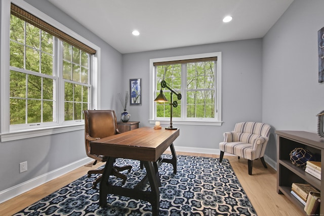 home office with baseboards, a healthy amount of sunlight, recessed lighting, and wood finished floors