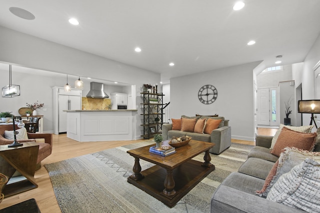living area with light wood-type flooring and recessed lighting
