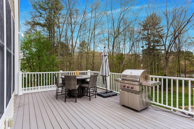 deck with area for grilling and outdoor dining area