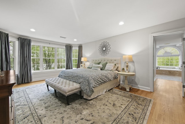 bedroom featuring baseboards, recessed lighting, visible vents, and wood finished floors