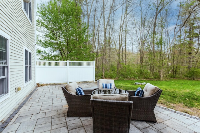 view of patio featuring outdoor lounge area and fence