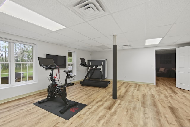 workout room featuring visible vents, wood finished floors, baseboards, and a paneled ceiling