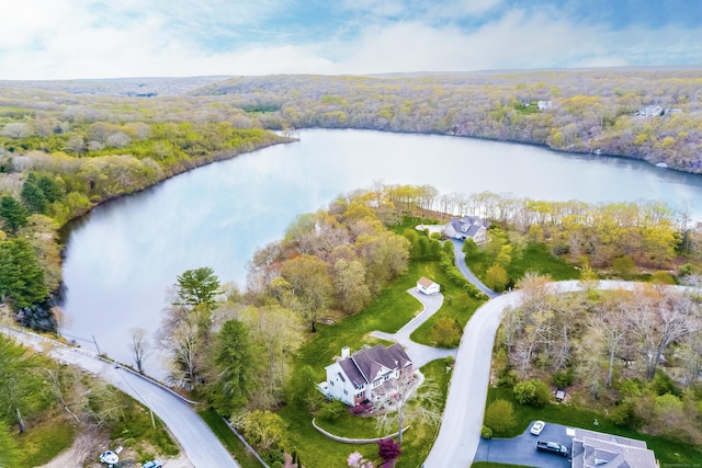 aerial view with a wooded view and a water view