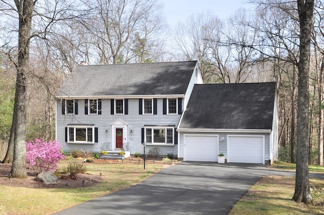 187 Hollister Dr, Avon, CT 06001 - colonial house with a garage, driveway, a chimney, and roof with shingles