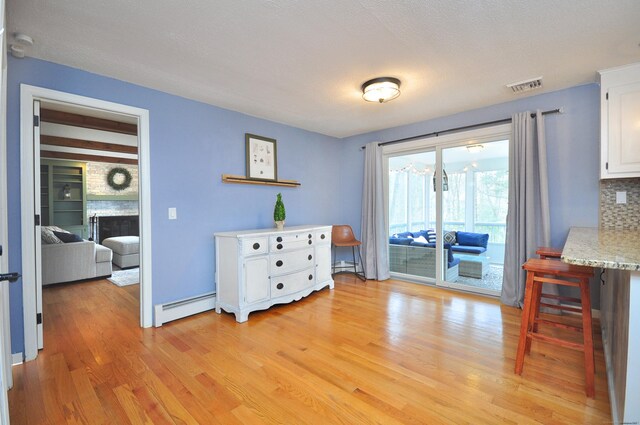 187 Hollister Dr, Avon, CT 06001 - dining area with baseboard heating, visible vents, and light wood-style flooring