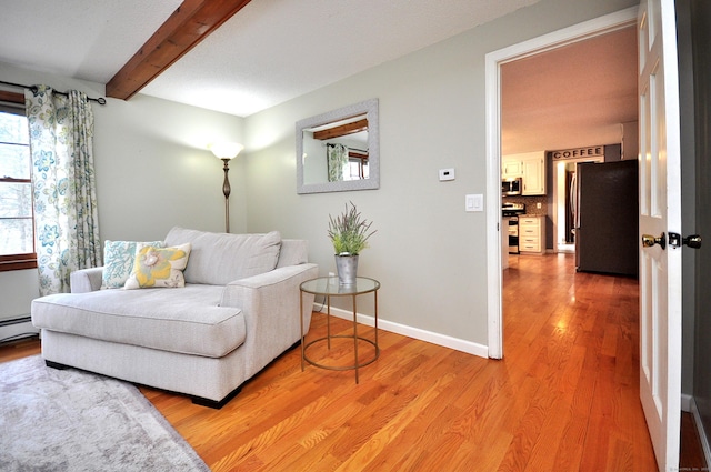187 Hollister Dr, Avon, CT 06001 - living area featuring baseboards, beamed ceiling, and light wood-style flooring