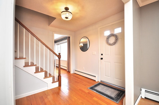 187 Hollister Dr, Avon, CT 06001 - entrance foyer with a baseboard radiator, wood finished floors, and stairs