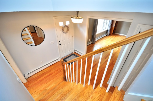 187 Hollister Dr, Avon, CT 06001 - entrance foyer featuring a baseboard radiator, a chandelier, light wood-type flooring, and stairway