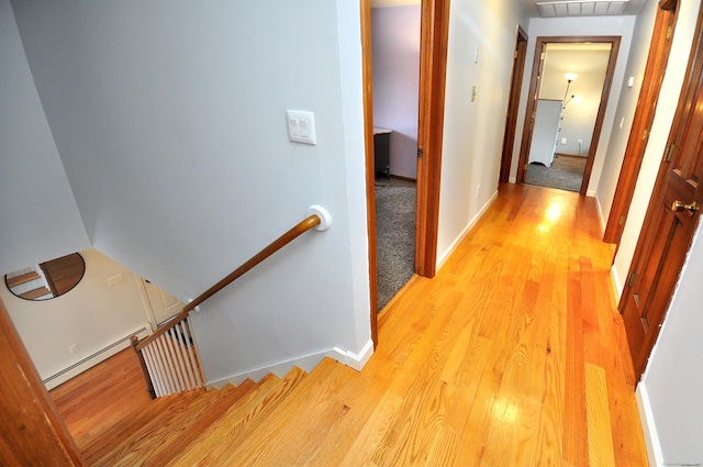 187 Hollister Dr, Avon, CT 06001 - hall with a baseboard heating unit, visible vents, light wood finished floors, and an upstairs landing