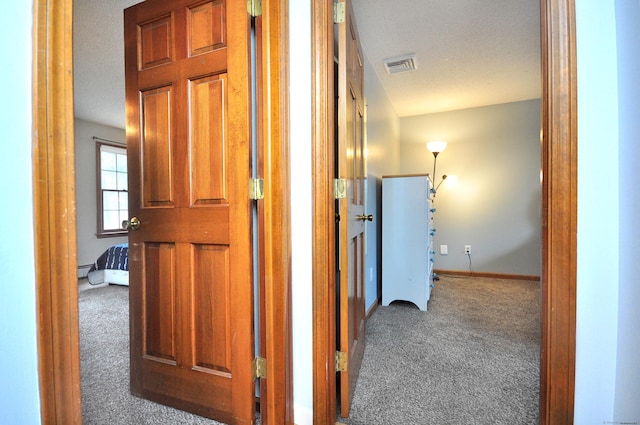 187 Hollister Dr, Avon, CT 06001 - corridor featuring baseboard heating, a textured ceiling, baseboards, carpet flooring, and visible vents