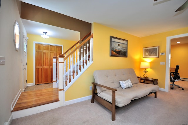 entryway featuring ceiling fan, stairway, carpet, and baseboards