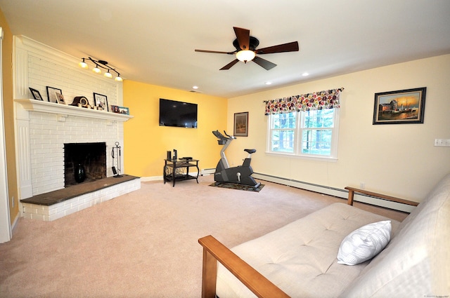 workout area with carpet flooring, a fireplace, a ceiling fan, baseboards, and a baseboard radiator