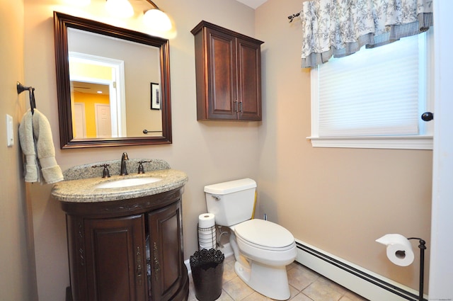 half bath featuring a baseboard heating unit, tile patterned flooring, toilet, and vanity