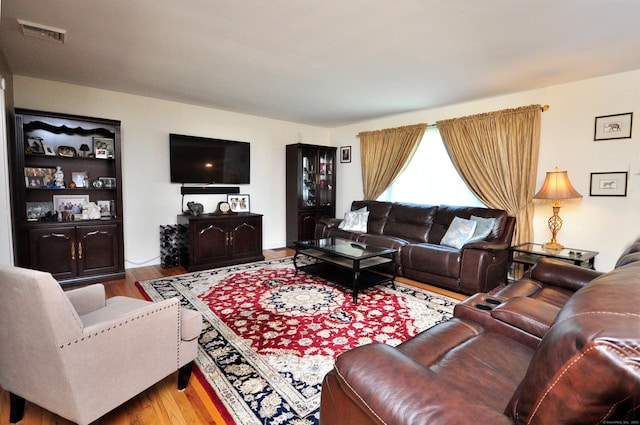 living area featuring wood finished floors and visible vents
