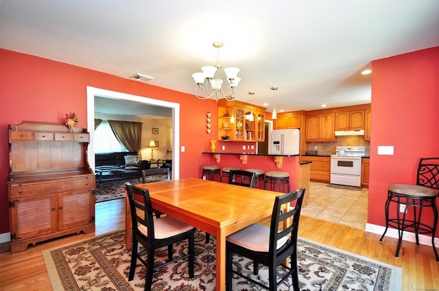 dining area with recessed lighting, visible vents, a chandelier, and light wood-style floors