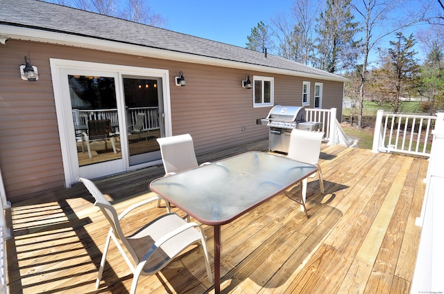 deck featuring area for grilling and outdoor dining area