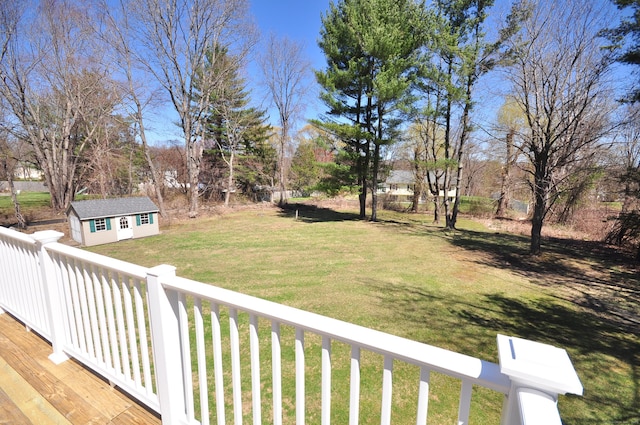 view of yard featuring an outdoor structure and a wooden deck