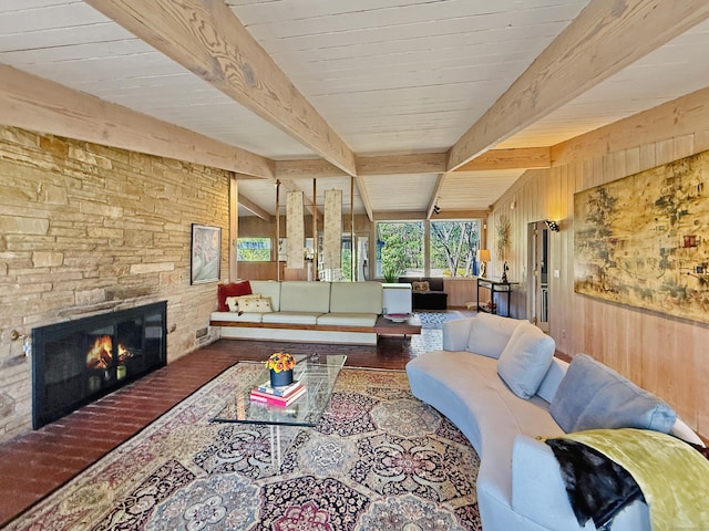 1177 Rock Rimmon Rd, Stamford, CT 06903 - living room featuring beam ceiling, wood walls, wood finished floors, and a stone fireplace