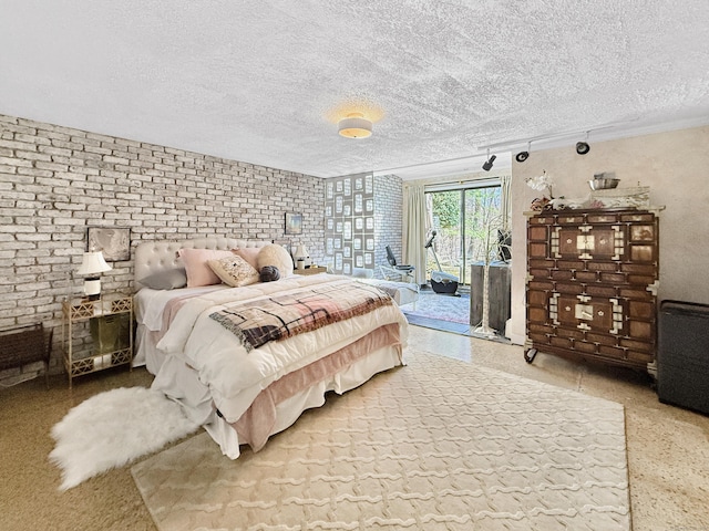 1177 Rock Rimmon Rd, Stamford, CT 06903 - bedroom with access to exterior, a textured ceiling, and brick wall