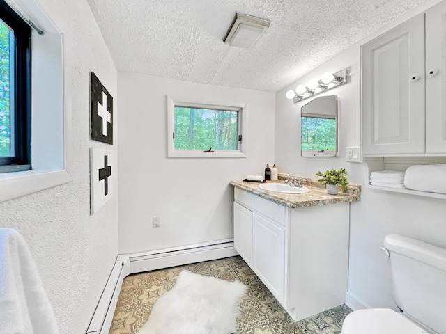1177 Rock Rimmon Rd, Stamford, CT 06903 - bathroom featuring a baseboard radiator, a baseboard heating unit, toilet, vanity, and a textured ceiling