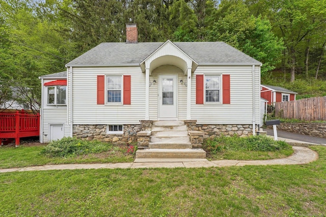 bungalow-style house featuring a chimney, entry steps, and roof with shingles