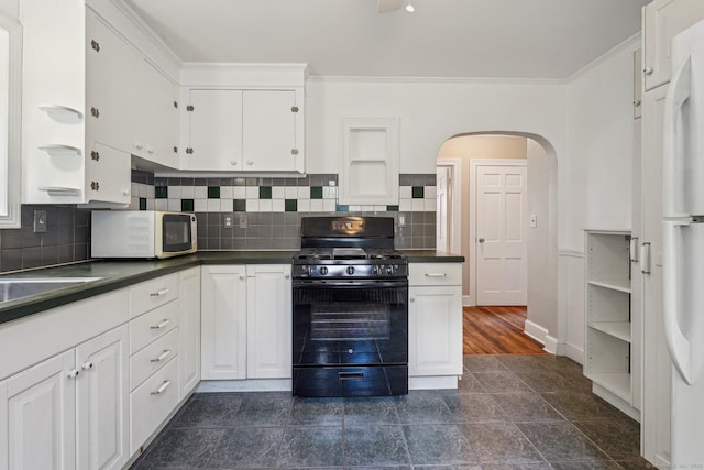 kitchen featuring black gas stove, dark countertops, arched walkways, white cabinets, and ornamental molding