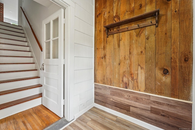 interior space featuring wood walls and wood finished floors