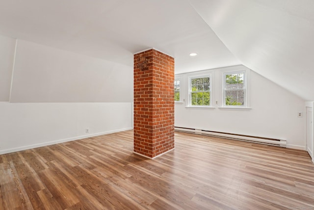 bonus room featuring baseboard heating, wood finished floors, vaulted ceiling, baseboards, and recessed lighting