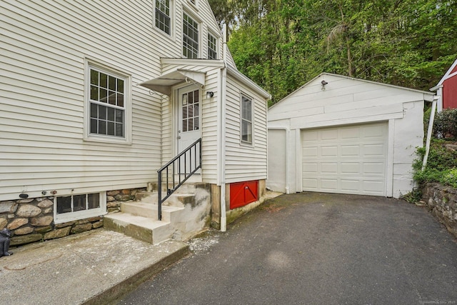 property entrance featuring driveway and a detached garage