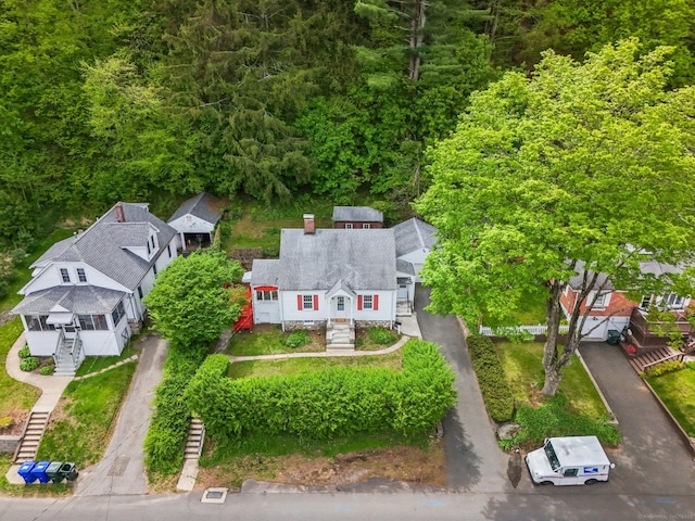 aerial view of property and surrounding area with a forest
