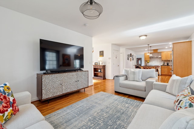 living area with light wood finished floors and baseboards