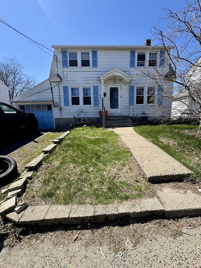 colonial inspired home with a front lawn and a chimney