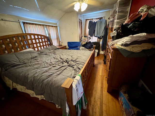 bedroom featuring lofted ceiling and wood finished floors