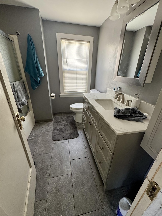 full bathroom with tile patterned floors, vanity, and toilet