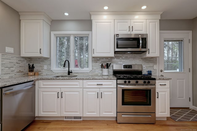 245 Paradise Ave, Hamden, CT 06514 - kitchen with a sink, tasteful backsplash, light stone countertops, and stainless steel appliances
