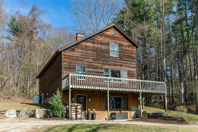 43 Greene Ave, North Canaan, CT 06018 - rear view of property with a wooden deck, a chimney, and a forest view
