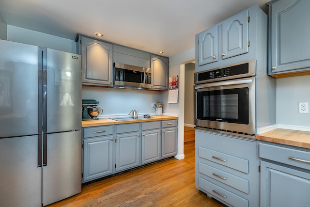 43 Greene Ave, North Canaan, CT 06018 - kitchen with appliances with stainless steel finishes, wood counters, light wood-type flooring, gray cabinets, and recessed lighting