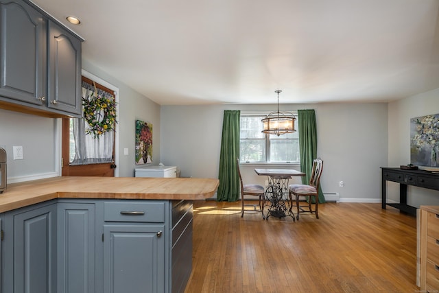 43 Greene Ave, North Canaan, CT 06018 - dining space with dark wood-style flooring, a baseboard heating unit, baseboards, and a chandelier