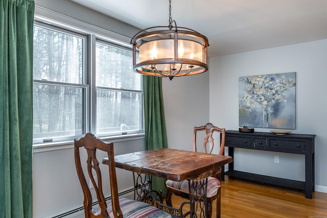43 Greene Ave, North Canaan, CT 06018 - dining space featuring a chandelier, wood finished floors, and a baseboard heating unit