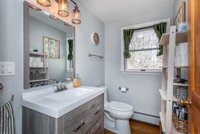 43 Greene Ave, North Canaan, CT 06018 - bathroom featuring a baseboard radiator, toilet, wood finished floors, and vanity