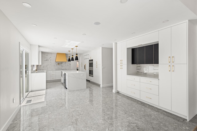 unfurnished living room with granite finish floor, recessed lighting, a sink, and baseboards