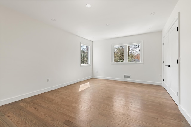 unfurnished bedroom featuring recessed lighting, light wood-style floors, visible vents, and baseboards