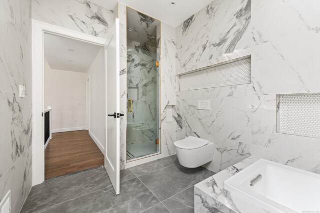 full bath with marble finish floor, toilet, a marble finish shower, tile walls, and a garden tub