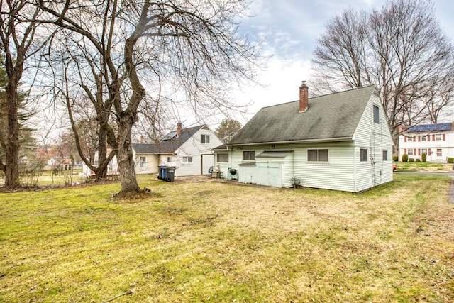 203 Westminster St, Hartford, CT 06112 - rear view of property with a lawn, a chimney, and a shingled roof