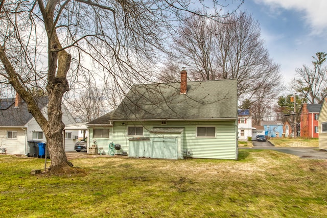 203 Westminster St, Hartford, CT 06112 - back of house with a chimney, roof with shingles, and a lawn