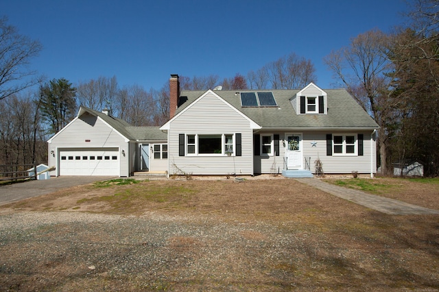 95 Hop Brook Rd, Simsbury, CT 06070 - view of front facade with a chimney, a garage, driveway, roof mounted solar panels, and roof with shingles