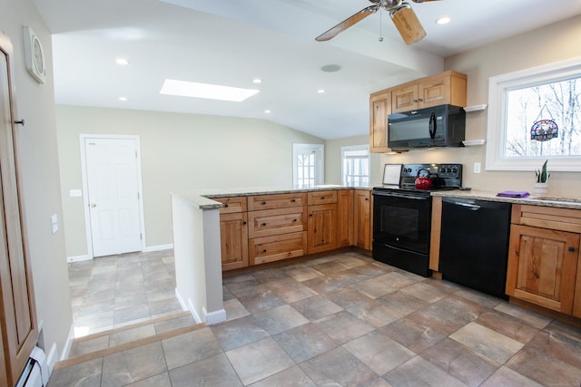 95 Hop Brook Rd, Simsbury, CT 06070 - kitchen featuring black appliances, a peninsula, a skylight, baseboards, and light stone countertops