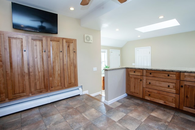 95 Hop Brook Rd, Simsbury, CT 06070 - kitchen with a baseboard heating unit, baseboards, a skylight, light stone counters, and ceiling fan
