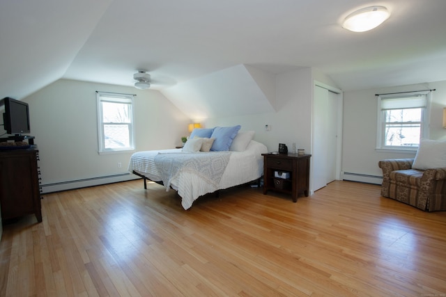 95 Hop Brook Rd, Simsbury, CT 06070 - bedroom featuring a baseboard heating unit, vaulted ceiling, light wood-style floors, and multiple windows