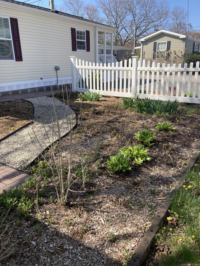 view of side of home featuring fence